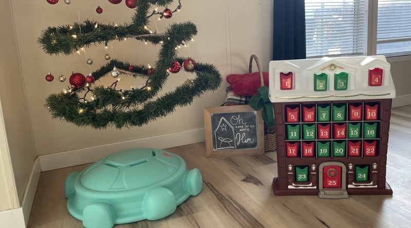 Step2 My First Christmas Advent Calendar set in a cozy Christmas corner with garland tree, ornaments, and holiday decor.